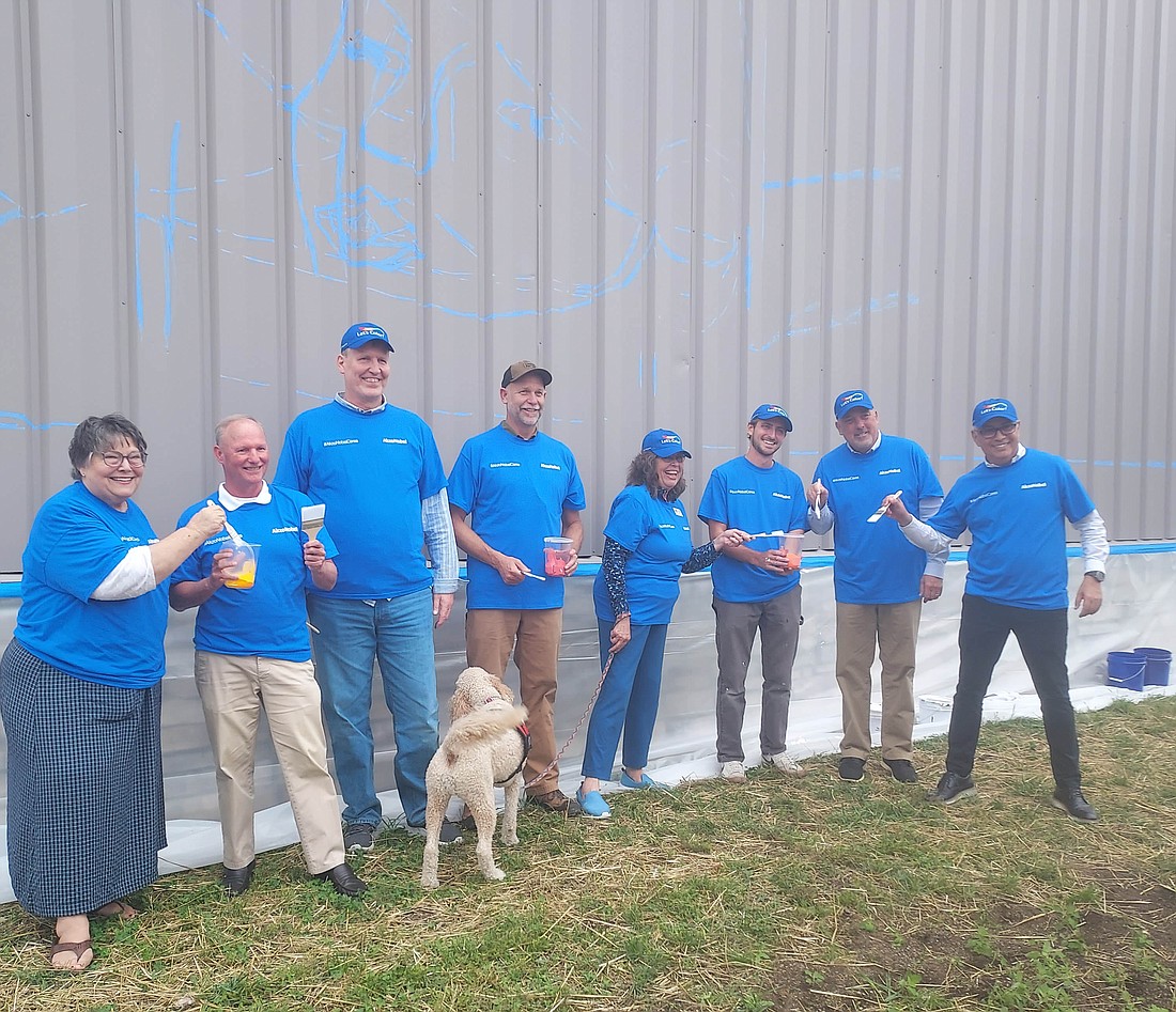 Pictured (L to R) are Susie Light, Warsaw Public Arts Commission chair; Terry Sweeney, downtown development director for Main Street Warsaw; Jim Swanson, YMCA CEO; Cary Groninger, of G & G Hauling & Excavating Inc.; Warsaw Common Councilwoman Diane Quance; muralist Chris Catalogna; Scott Wiley, Kosciusko Chamber of Commerce member relations manager; and Hector Loyola, AkzoNobel Warsaw site manager. Photo by Jackie Gorski, Times-Union