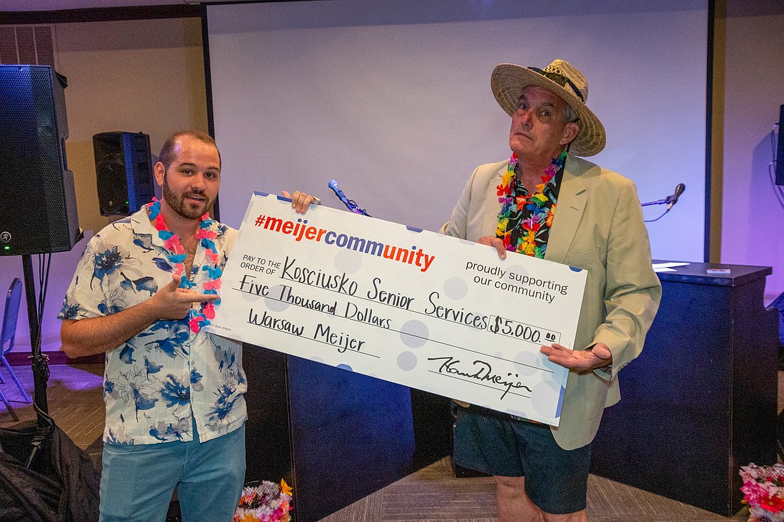 One of the large sponsors of the Dueling Pianos Fundraiser for Kosciusko Senior Services was Meijer. Pictured holding a $5,000 check from Meijer are Scott Clay (L), Kosciusko Senior Services Board of Directors member, and Jeff Owens, the evening’s master of ceremonies. Photo Provided