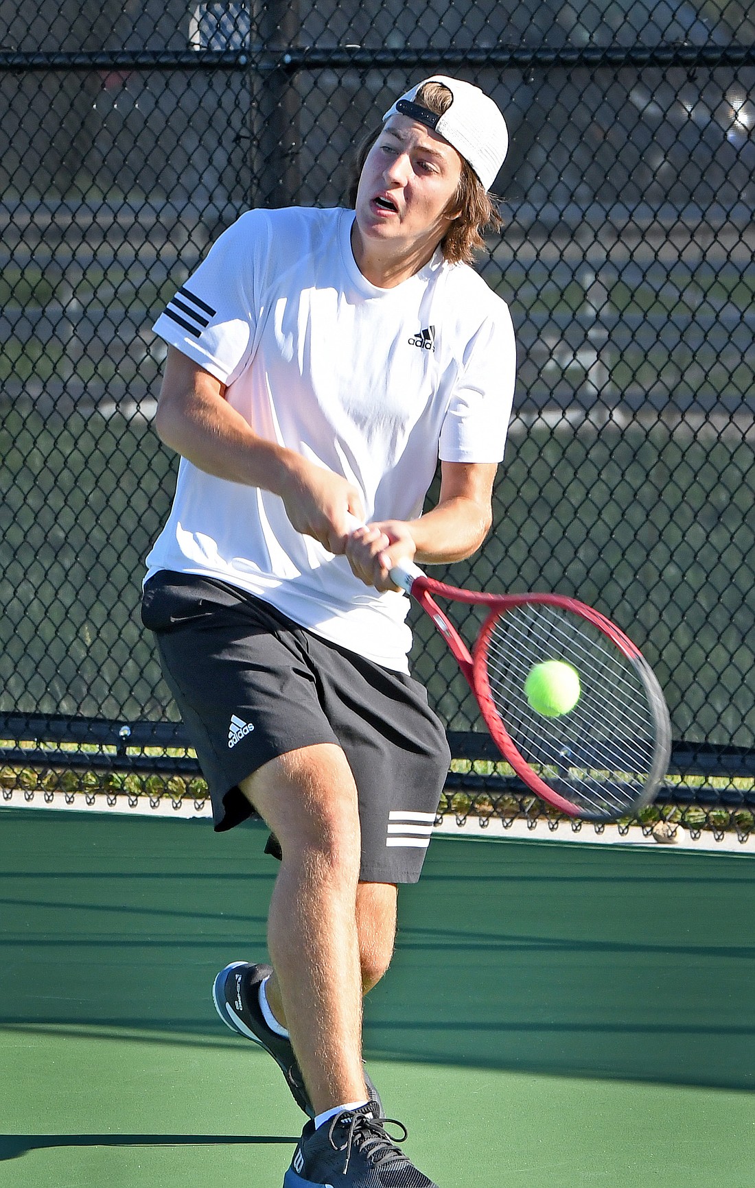 Junior Charles Norton of Warsaw uses a backhand return during his No. 1 singles match during Wednesday's sectional...Nieter