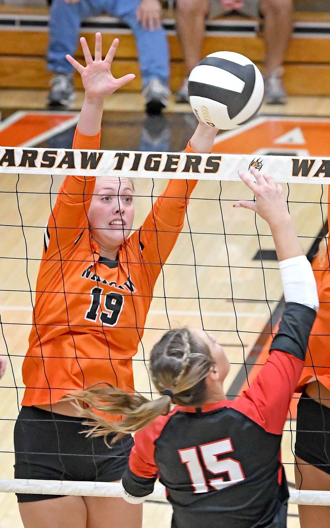 Senior Krista Lauck of Warsaw goes up to block the kill attempt of NorthWood's Sophia Barber during the second set...Nieter