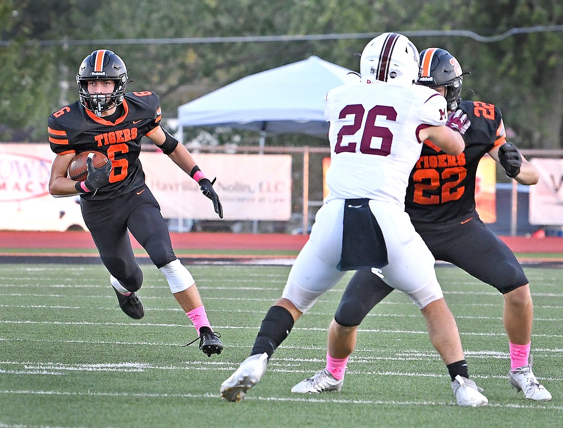 Warsaw senior Tristan Wilson picks up a block from junior teammate Fletcher Pohl after making a first quarter interception...Nieter