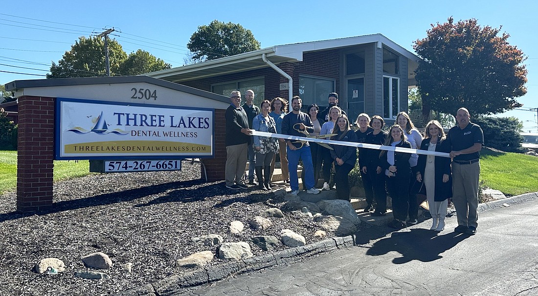 The Kosciusko Chamber of Commerce had a ribbon-cutting ceremony Monday for the rebranding and grand re-opening of Three Lakes Dental Wellness, 2504 E. Center St., Warsaw. Pictured are Dr. Dennis Pitsilides (center with scissors), members of his staff and Chamber staff and ambassadors. Photo by David Slone, Times-Union