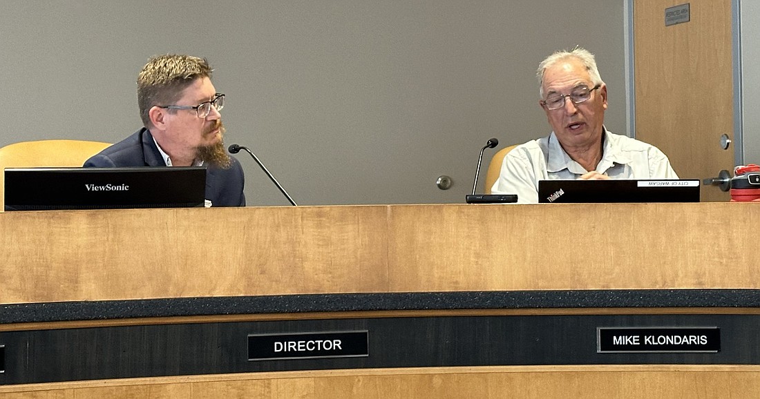 Warsaw Community and Economic Development Director Jeremy Skinner (L) listens to a question from Councilman Mike Klondaris (R) about the water line extension on North CR 100E. Photo by David Slone, Times-Union