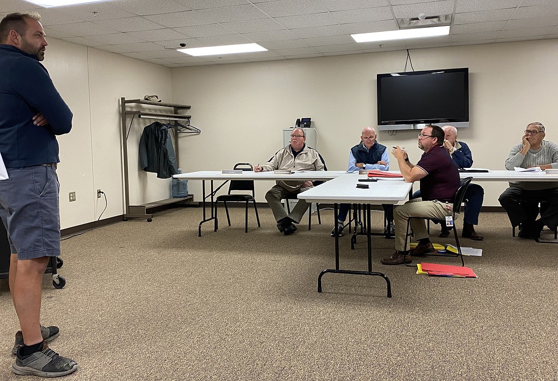 Michael Wilson (L) appears before the Kosciusko County Board of Zoning Appeals on Tuesday. Pictured seated are (L to R) Kevin McSherry, Lee Harman, Area Plan Director Matt Sandy, Randy Cox and Ron Robinson. Photo by Leah Sander, InkFreeNews