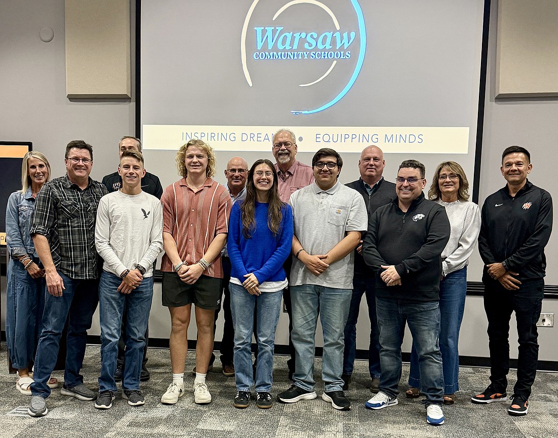 Pictured are Warsaw Area Career Center teacher Scott Greene, students Sutton Victa, Isaac Greene, Rex Arnold and Taylor Drang; Warsaw Community Schools Superintendent Dr. David Hoffert and the Warsaw School Board. Photo Provided.