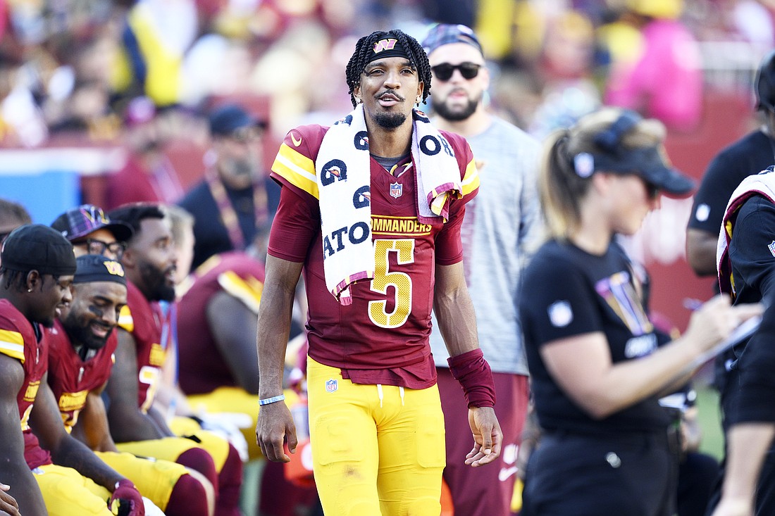 Washington Commanders quarterback Jayden Daniels (5) watches from the sidelines in the fourth quarter against the Cleveland Browns of an NFL football game in Landover, Md., Sunday, Oct. 6, 2024. (AP Photo/Nick Wass)