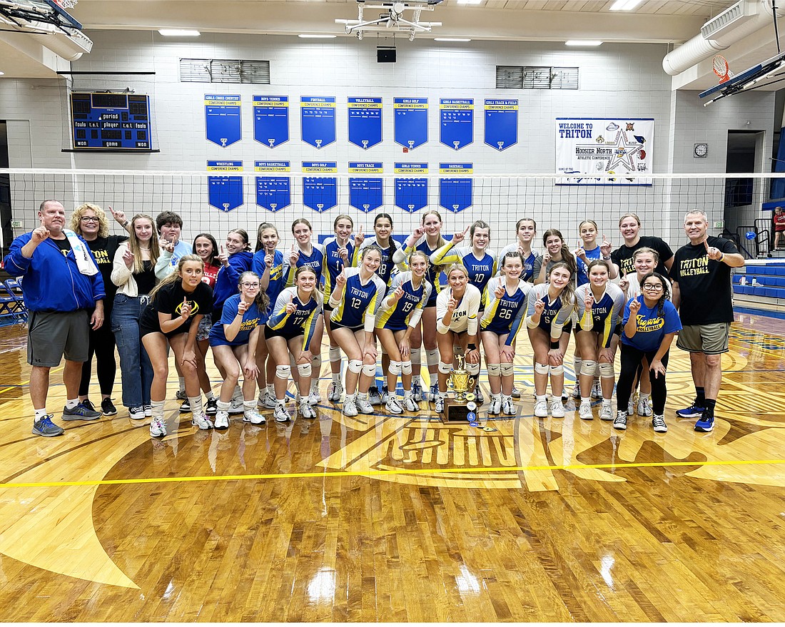 The Triton Volleeyball team celebrates after winning the Hoosier North Athletic Conference Championship with a victory over Caston Tuesday night.