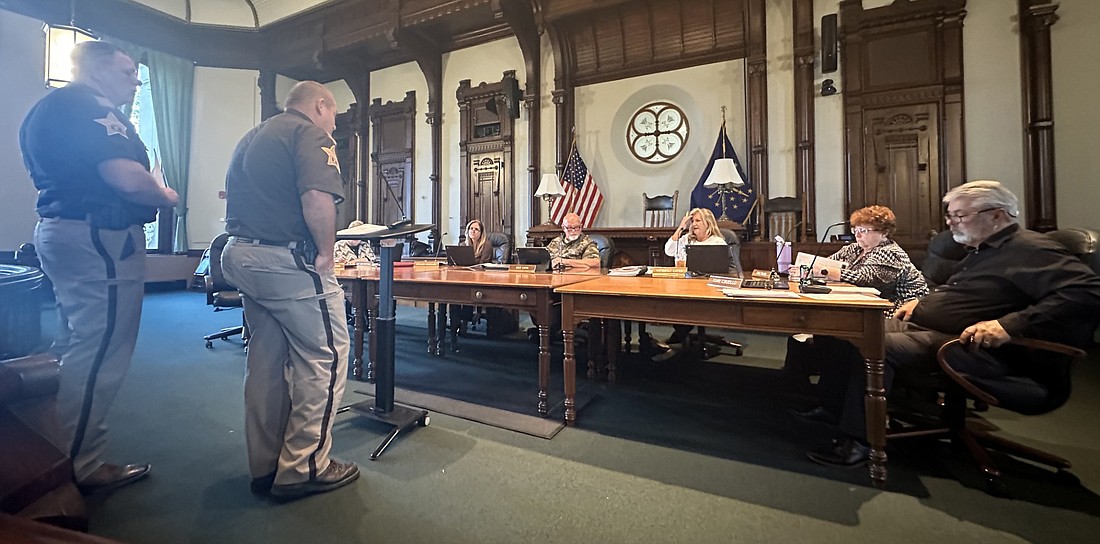 Kosciusko County Sheriff Jim Smith (L, standing) and Chief Deputy Chris McKeand (R, standing) present five requests for various matters to the Kosciusko County Council Thursday evening. Photo by David Slone, Times-Union