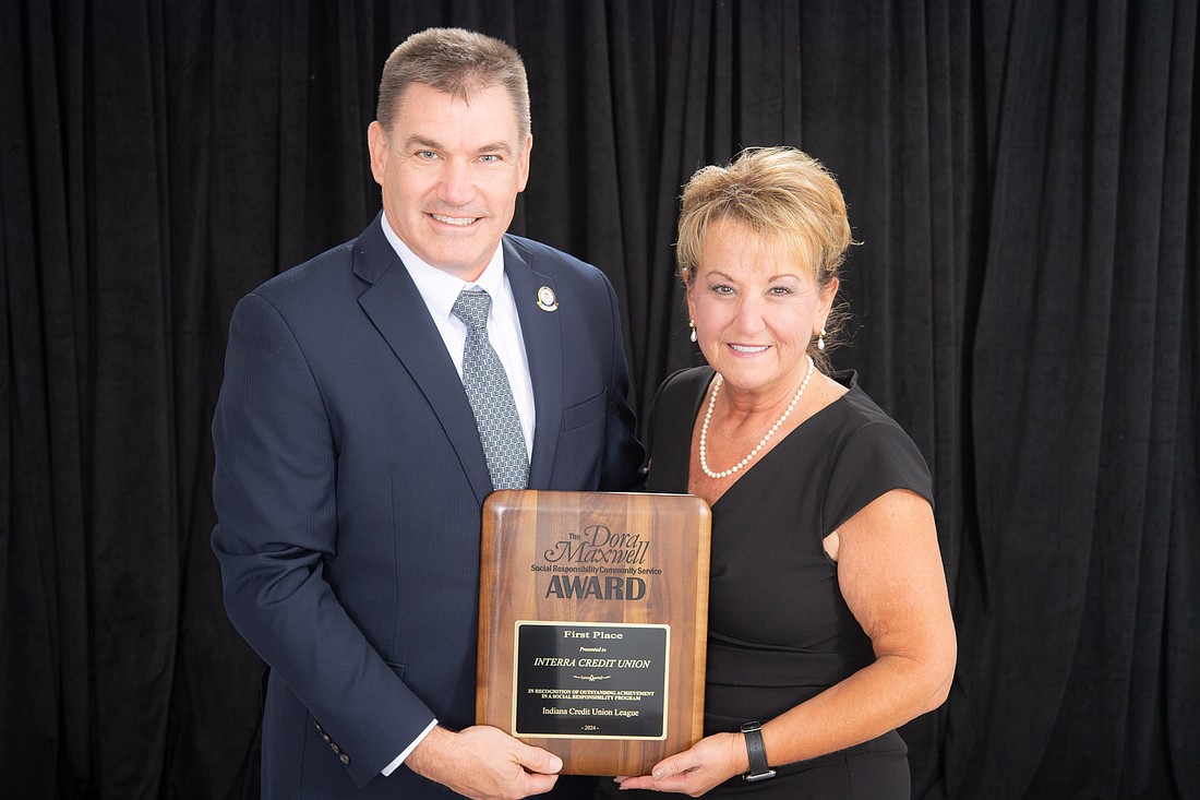 Jim Henning, Interra chief financial officer, accepts the Dora Maxwell Award from Nina Baker, Indiana Credit Union League chairwoman. Photo Provided