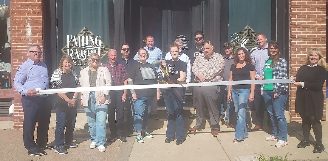 Pictured are Falling Rabbit owner Molly Hollar (holding scissors) and Kosciusko Chamber of Commerce staff and ambassadors. Photo by Jackie Gorski, Times-Union