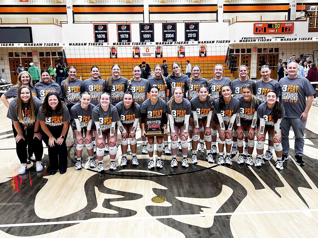 Pictured is the Warsaw volleyball team celebrating after defeating Concord Thursday to clinch its third straight Northern Lakes Conference title.