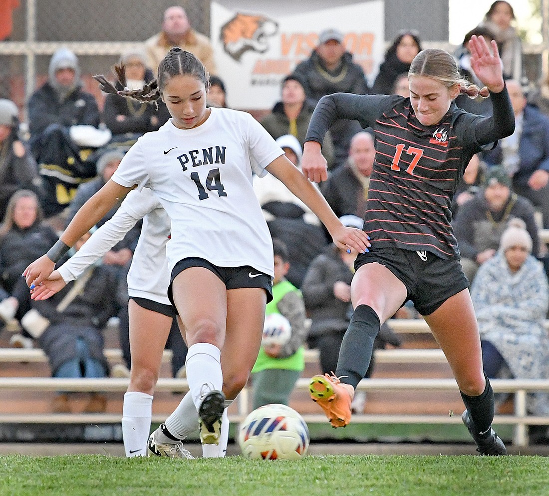 Natalia Souffront-Garcia (L) of Penn and Warsaw's Olivia Widner reach out for the ball during the first half...Nieter