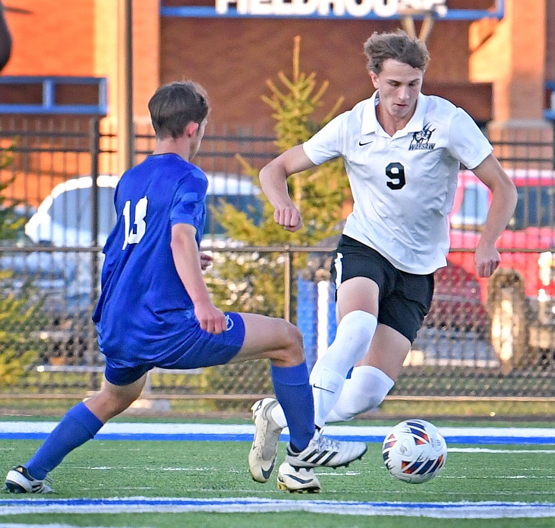 Warsaw senior Logan Lennox keeps control of the ball during Thursday evening's regional semi-final against Carroll...Nieter