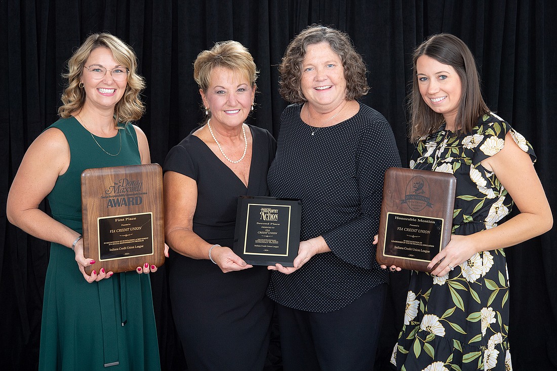 ICUL Chairwoman Nina Baker presents three awards to ViaCU President and CEO Cindy Kohlmorgen and marketing team members Michelle Peterson and Samantha Bacon.  Photo Provided