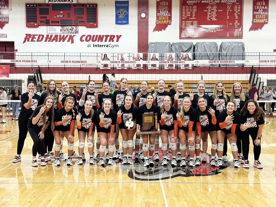 The Warsaw volleyball team holds up three fingers to signify its third straight sectional championship. The Lady Tigers defeated Concord 3-0 Saturday night to advance to the regional match. Photo by Connor McCann