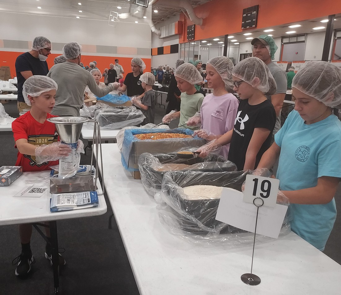 Feed My Starving Children had its first volunteer shift Monday night. Photo by Jackie Gorski, Times-Union