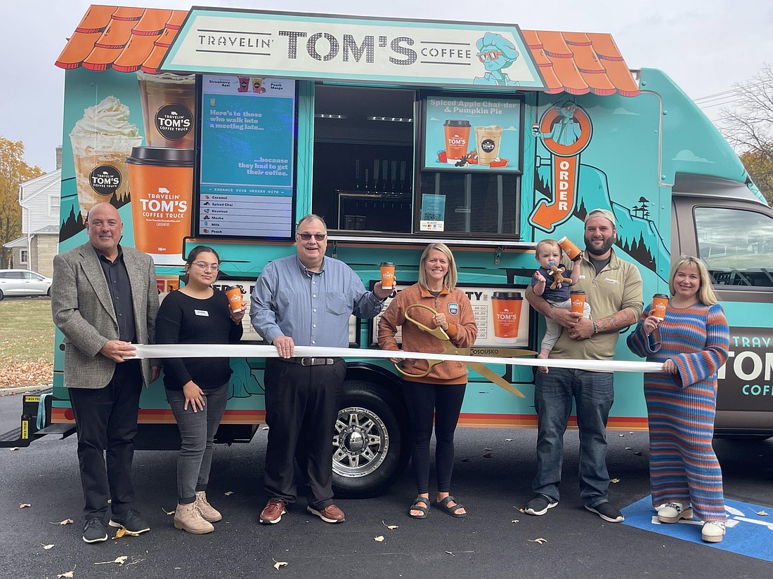 Pictured (L to R) are Kosciusko Chamber of Commerce Member Relations Manager Scott Wiley, Blanca Cervantes Pantoja, James Kofalt, Travelin Tom's Coffee of Marshall County owner Melinda Folkers, Roux Bianchini, Shawn Bianchini and Kosciusko Chamber of Commerce Events Coordinator Nora Christiansen. Photo by Liz Adkins, InkFreeNews