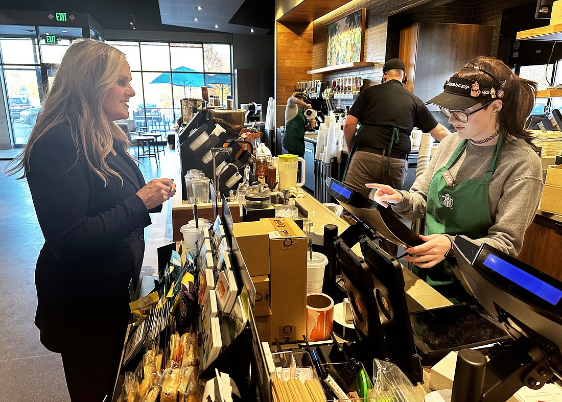 Jennifer McCormick (L), the Democratic Party’s candidate for Indiana governor, orders a coffee Friday afternoon at the Starbucks in Warsaw from Emma Tucker (R). McCormick stopped in the Starbucks on her way to Fort Wayne for an in-person interview with the Times-Union. Photo by David Slone, Times-Union