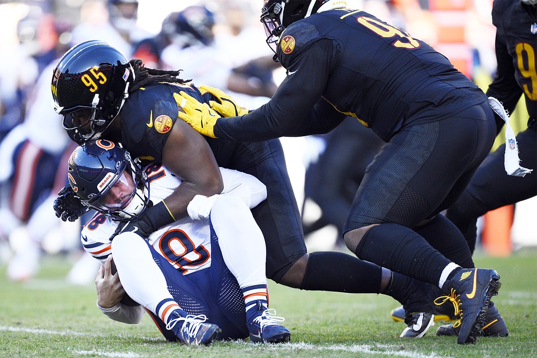 Chicago Bears quarterback Caleb Williams (18) is sacked for a 6-yard loss by Washington Commanders defensive tackle Jer'Zhan Newton (95) in the first half of an NFL football game Sunday, Oct. 27, 2024, in Landover, Md. (AP Photo/Nick Wass)