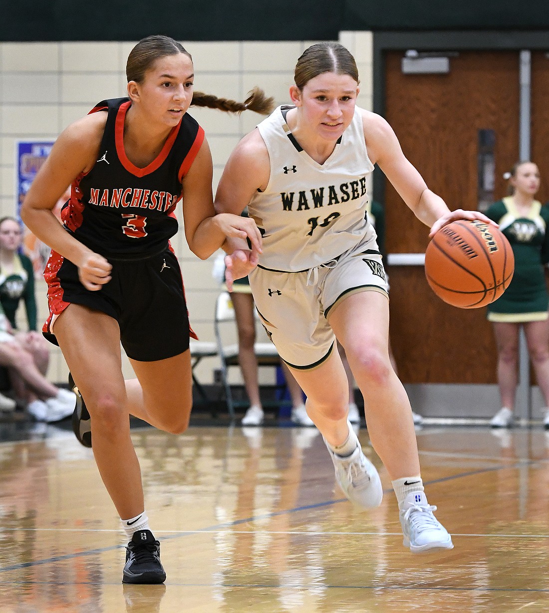 Wawasee senior Mackenzie Hackleman heads to the basket as Ava Sautter of Manchester gives chase...Nieter