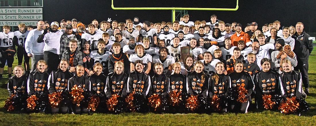 The Warsaw football team celebrates after winning its second sectional title in school history, 31-28 over No. 1 Concord, Friday night. The Tigers scored the game-winning touchdown with 13 seconds left. Photo by Gary Nieter