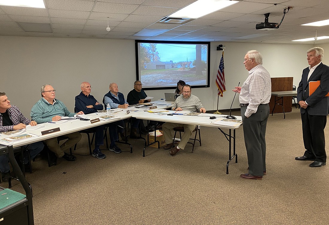 Listening to a request at the Kosciusko County Board of Zoning Appeals meeting on Tuesday are (seated, L to R) John Beer, Kevin McSherry, Lee Harman, Randy Cox, Ron Robinson and Kosciusko County Area Plan Director Matt Sandy. Standing at right is attorney Steve Snyder with petitioner Brad Quinn behind him. Photo by Leah Sander, InkFreeNews