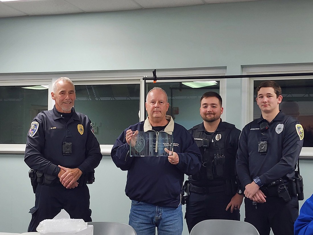 North Webster Town Marshal Greg Church was recognized by his fellow officers for his 30 years of service on the police department. Pictured (L to R) are officer David May, Church and officers James Curtis and Chase Wroblewski. Photo by Deb Patterson, InkFreeNews