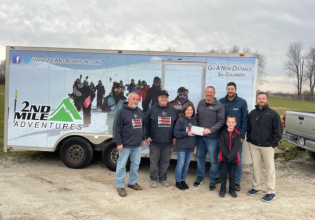 Second Mile Adventures hands the title of the trailer to Sleep in Heavenly Peace. Pictured (L to R) are Mike Webb, Rory Kiphart, Becky Kiphart, Nate Gernert, Kyle Alcorn, Timothy Gernert and Matt Mach. Photo by Madison Hart, InkFreeNews.