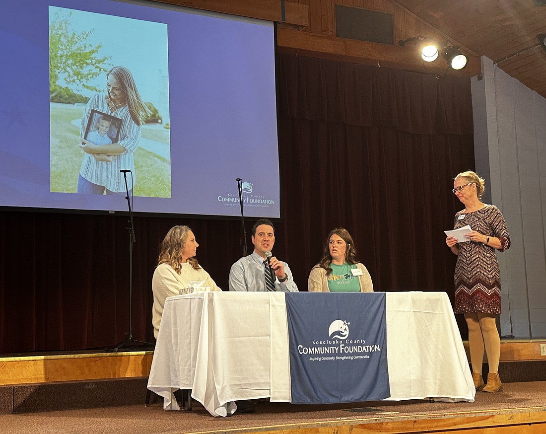 Kosciusko County Community Foundation CEO Stephanie Overbey (standing, R) moderates a panel discussion with (L to R) Keri Fox, Matt Deeds and Kelsie Herman. Photo by David Slone, Times-Union.