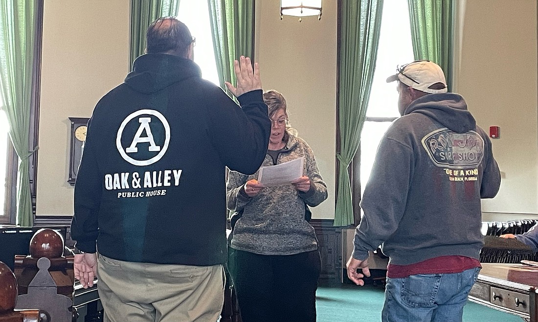 Chris Polk (L) and Mike Loher (R) were sworn in by County Auditor Alyssa Schmucker (C) as new members of the Kosciusko County Convention, Recreation and Visitor Commission on Wednesday. Photo by Madison Hart, InkFreeNews.