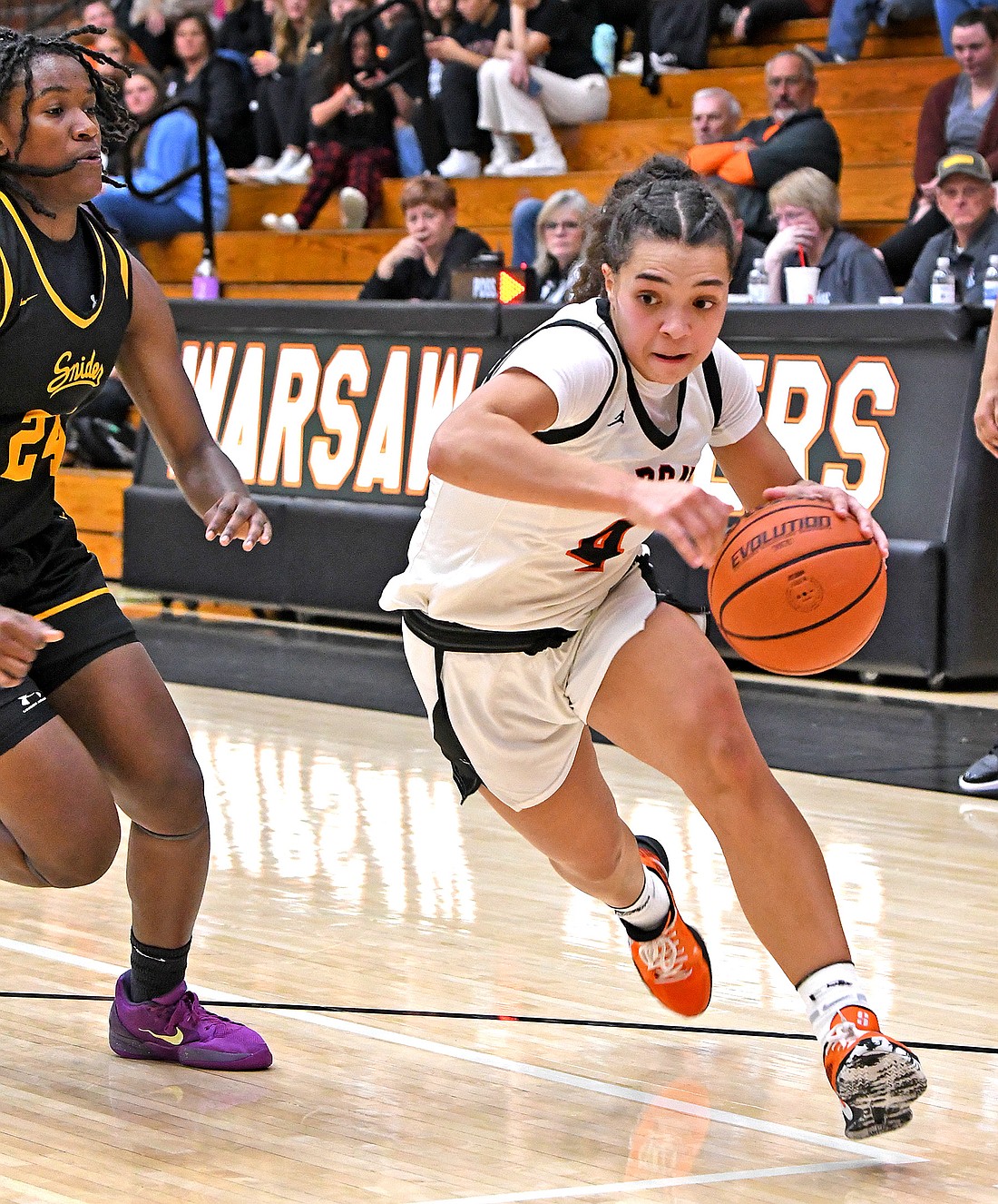 Warsaw junior Alexis Neely drives to the basket during the first quarter...Nieter