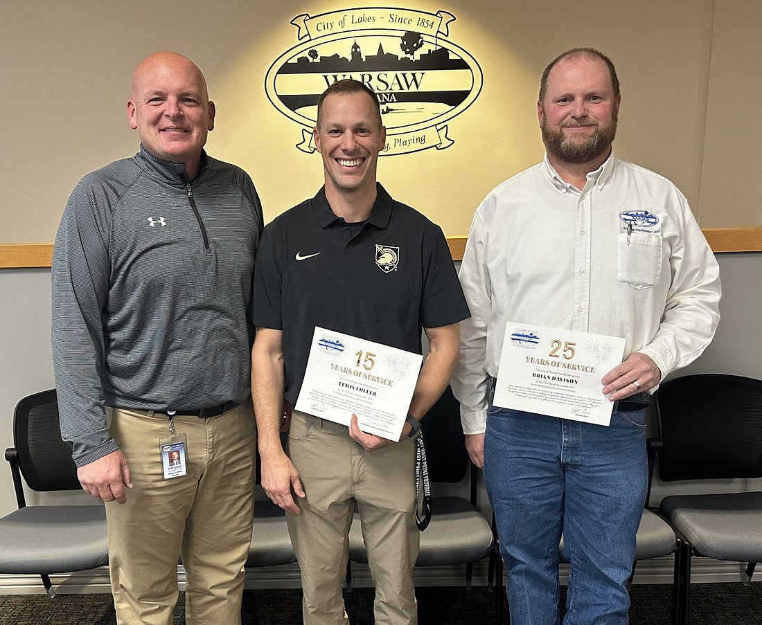 Warsaw Mayor Jeff Grose (L) poses for a photo with Warsaw Police Department Sgt. Lewis Fuller (C) and Wastewater Treatment Utility Superintendent Brian Davison (R) for their 15 and 25 years of service, respectively. Not pictured is WPD Det. Sgt. Ryan Moore, who has served the city for 15 years. Photo by David Slone, Times-Union