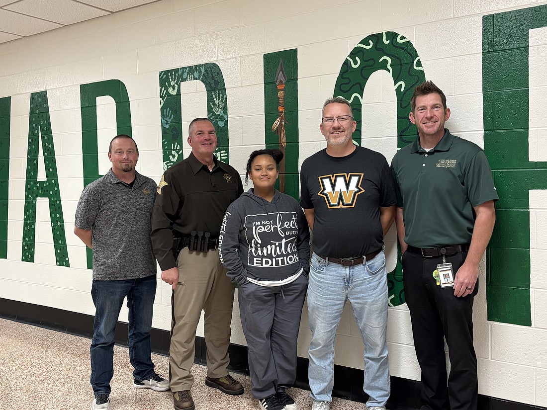 Pictured are Brent Berkeypile, Wawasee Middle School principal; Kosciusko County Sheriff’s Office deputy Doug Light; Angel Hochstetler, DARE essay award winner; Dan Gause, North Elementary fifth-grade teacher; and Lee Snider, North Webster Elementary School principal. Photo Provided