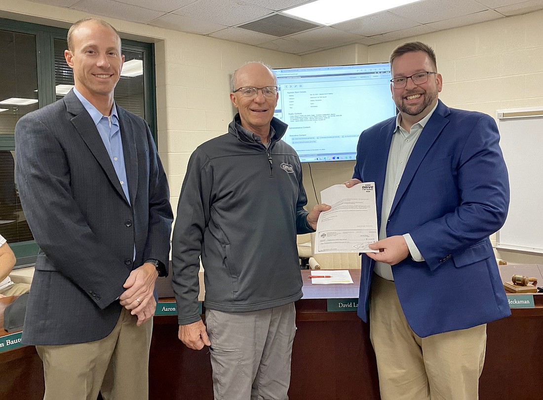 The Tippecanoe Valley School Board accepted more than $3,000 from Kerlin Ford of Silver Lake for Tippecanoe Valley High School from a test-drive event at a home football game in August. Pictured (L to R) are TVSC Board President Adam Heckaman, Kerlin Ford co-owner Rick Kerlin and TVHS Principal Brandon Kresca. Photo by Leah Sander, InkFree News