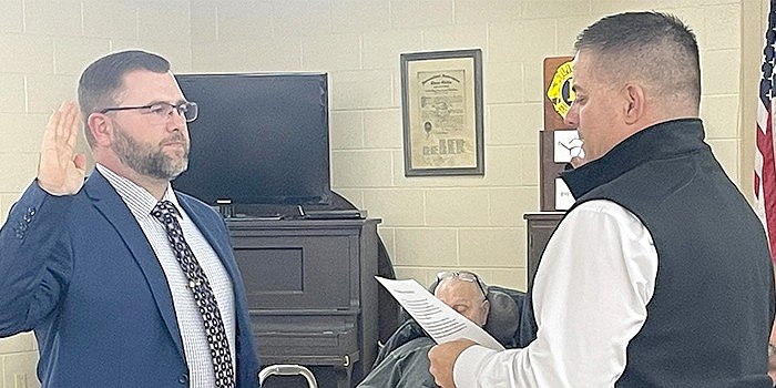 Trevor Long is sworn in as Claypool's new town marshal by town attorney Andrew Grossnickle during its council meeting Tuesday. Photo by Liz Shepherd, InkFreeNews