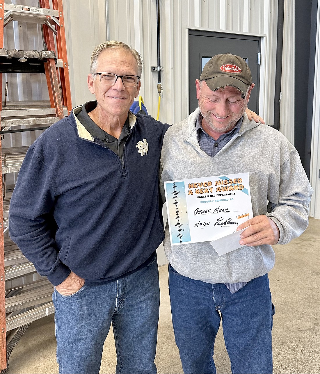 Warsaw Parks and Recreation Department mechanic George Music (R) won the department’s “Never Missed a Beat Award” for October. With him is Warsaw Parks and Recreation Department Superintendent Larry Plummer. Photo Provided.