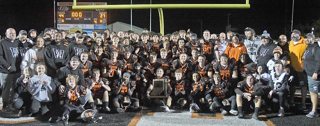 The Warsaw football team celebrates after winning the first regional championship in school history against Lafayette Jefferson last Friday. Photo by Gary Nieter