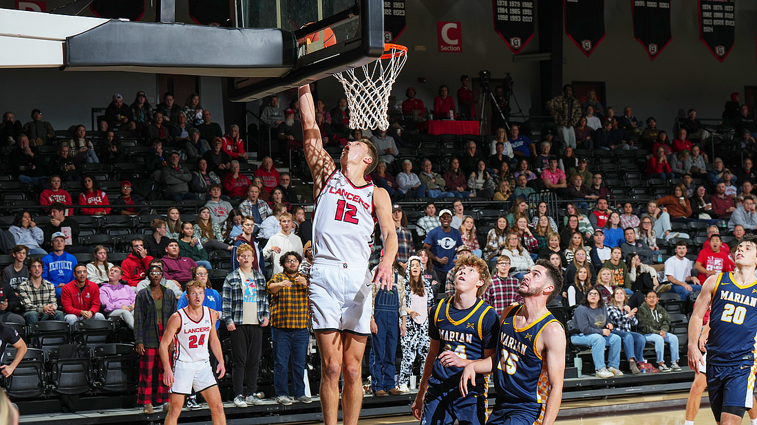 Pictured is Ian Raasch finishing off a fastbreak layup during Wednesday's win for Grace's men's basketball team