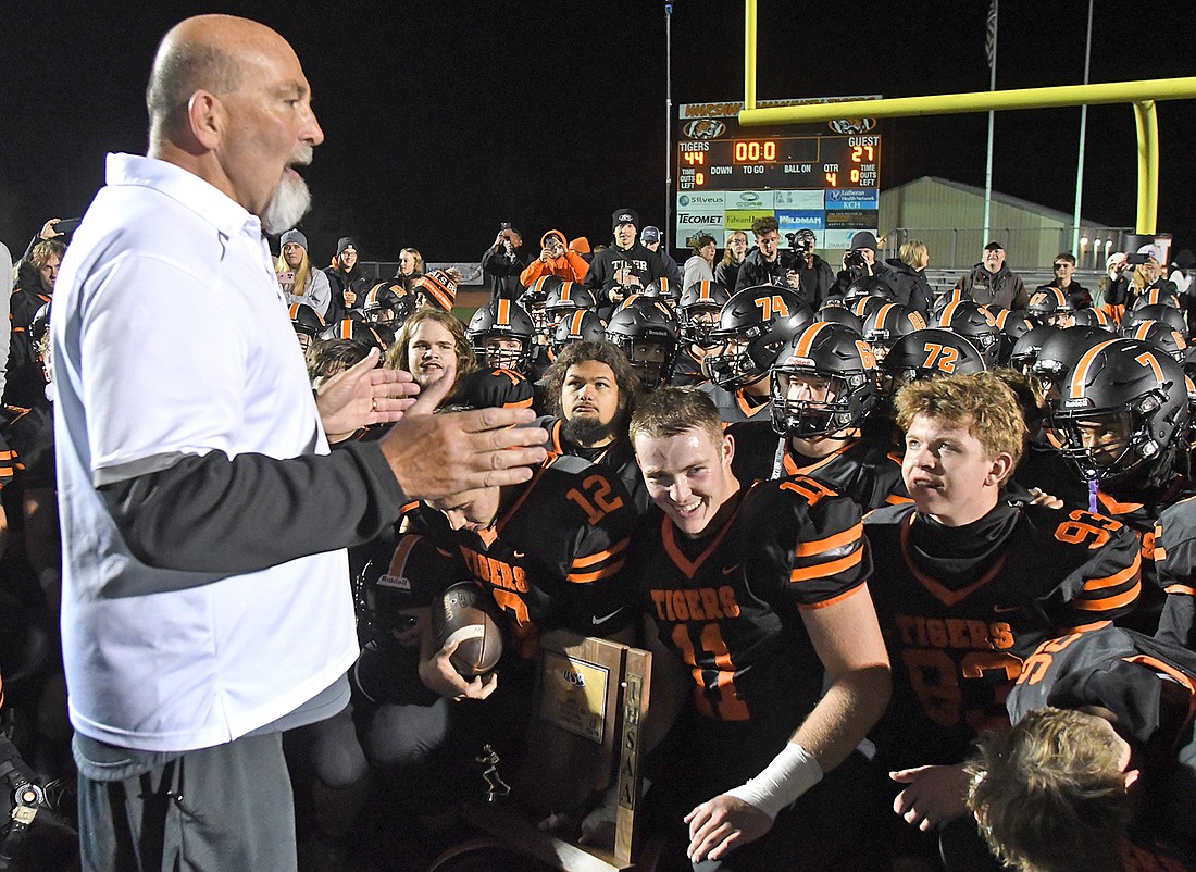 Warsaw head coach Bart Curtis talks with his players after the regional championship win...Nieter