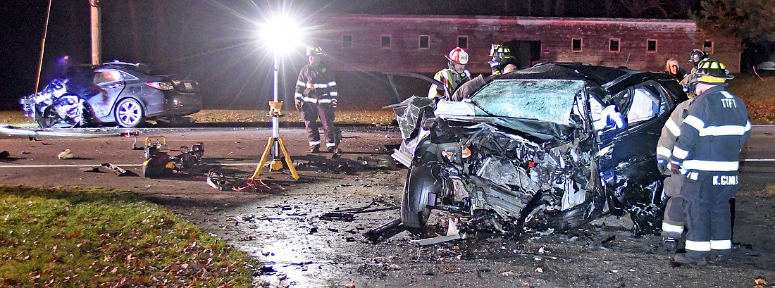 Officials investigate the scene of Thursday night's double fatal accident involving two vehicles on Old Road 30, east of Ind. 13.