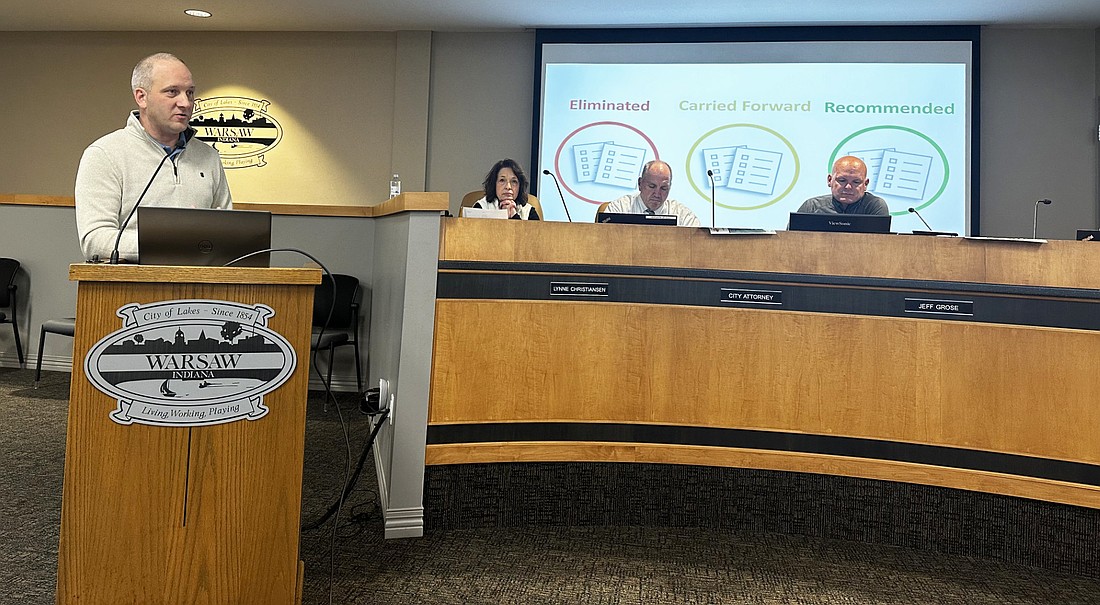 Rusty Holt (L), study manager for the ProPEL U.S. 30 study, gives a presentation to the Warsaw Common Council Monday night. Pictured seated (L to R) are Clerk-Treasurer Lynne Christiansen, city attorney Scott Reust and Warsaw Mayor Jeff Grose. Photo by David Slone, Times-Union