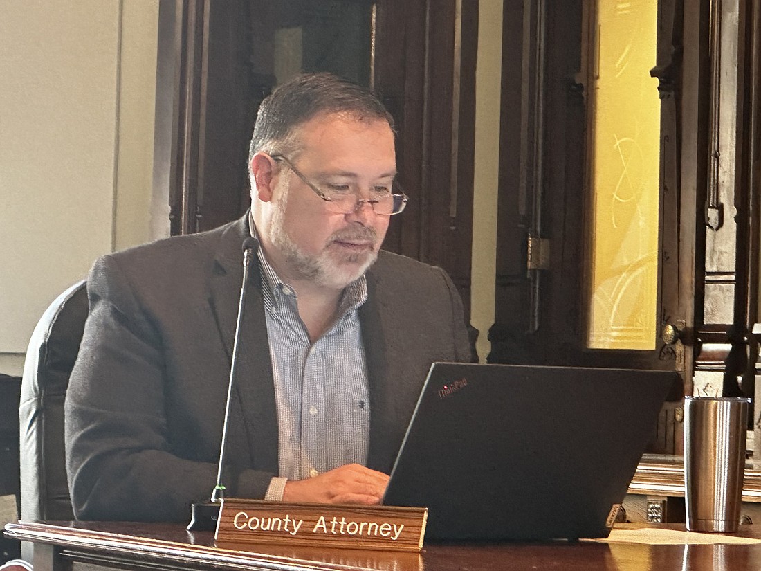 County attorney Ed Ormsby reads portions of the memorandum of understanding between the city of Warsaw and Kosciusko County to the county commissioners regarding a parking garage project. Photo by David Slone, Times-Union