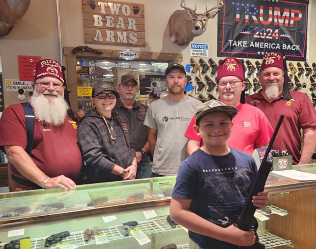 Pictured (L to R) are, foreground: Clayton Folk, gun winner; back: Scott Wallace, co-chair, Shrine Turkey Shoot; Skyler Miller, Two Bear Arms; Don Wallen, Two Bear Arms: Lawrence Folk, father of winner; Randy Riner, co-chair, Shrine Turkey Shoot; and Jeff Kinsey, Kosciusko Shrine Club president. Photo Provided.