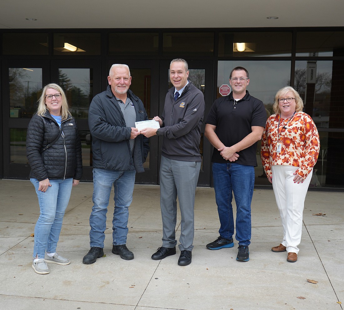 Kristy and Jeff Hooker, along with Max Kinsey present a pancake breakfast donation (organized by United Steelworkers Local 809 and Warsaw’s Professional Firefighters Local 5461) to Warsaw Community Schools Superintendent Dr. David Hoffert and Edgewood Middle School Principal JoElla Hauselman. Photo Provided.