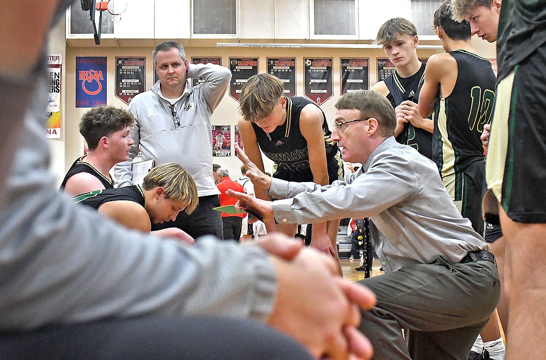 Wawasee head coach Lou Lefevre gives intructions to his team during a first quarter time out...Nieter