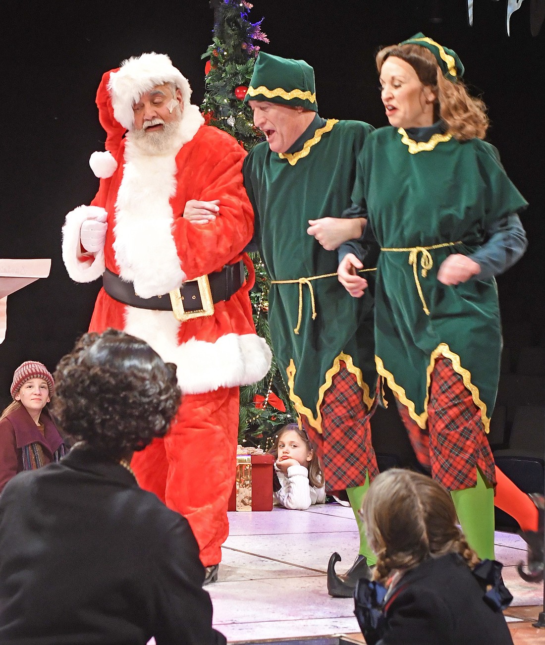 Pictured (L to R) are Lou Price as Kris Kringle with Tim Yocum and Kira Lace Hawkins, ensemble, in the Wagon Wheel Center for the Arts’ production of “Miracle on 34th Street, the Musical.” Photo by Gary Nieter, Times-Union