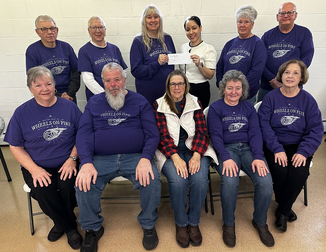 Wheels on Fire - Campus Crusaders presented checks to four cancer organizations Sunday at Beaver Dam Community Church. Pictured (L to R) are, front row: Linda Tucker, Dave Morehouse, Linda Heighway, Jill Lewis, Cris Randall; back row: Max Cumberland, Judy Cumberland; Chris Morehouse presenting a check to Eva Vega, client advocate, Cancer Services of Northeast Indiana; Lisa Tucker and Terry Randall. Photo by David Slone, Times-Union.