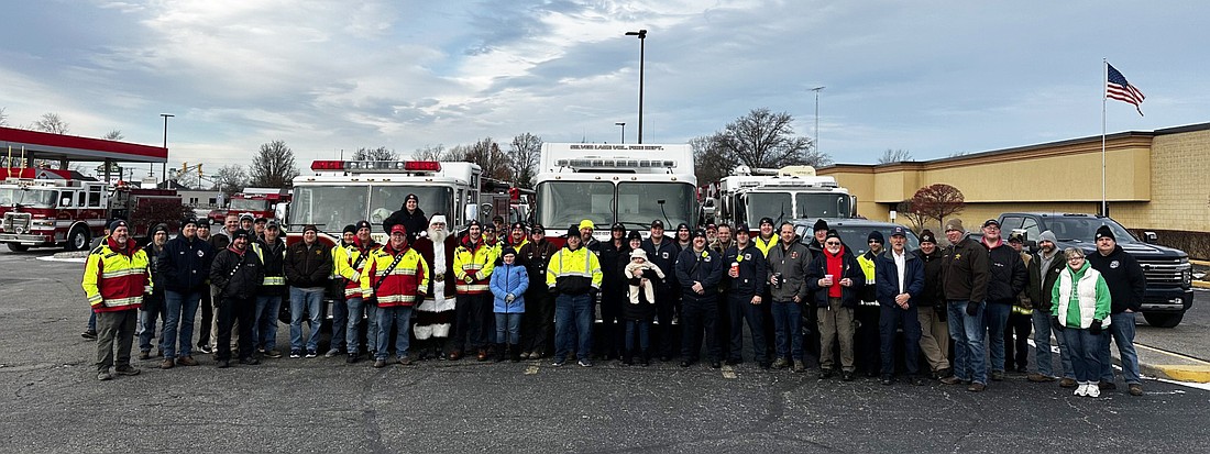 The county fire departments gather for a group photo at JB’s Furniture Saturday morning before heading to Martin’s in Warsaw to deliver their collection of toys for Toys for Tots. Photo by David Slone, Times-Union.