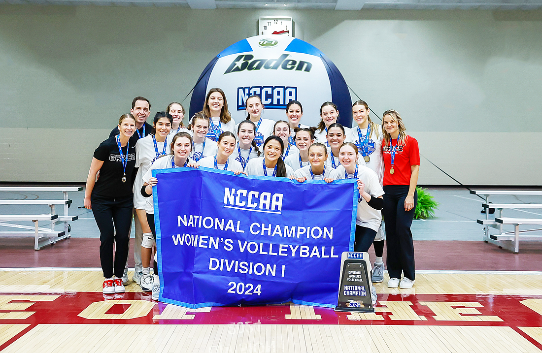 Pictured is Grace's volleyball team with its 2024 NCCAA national championship banner