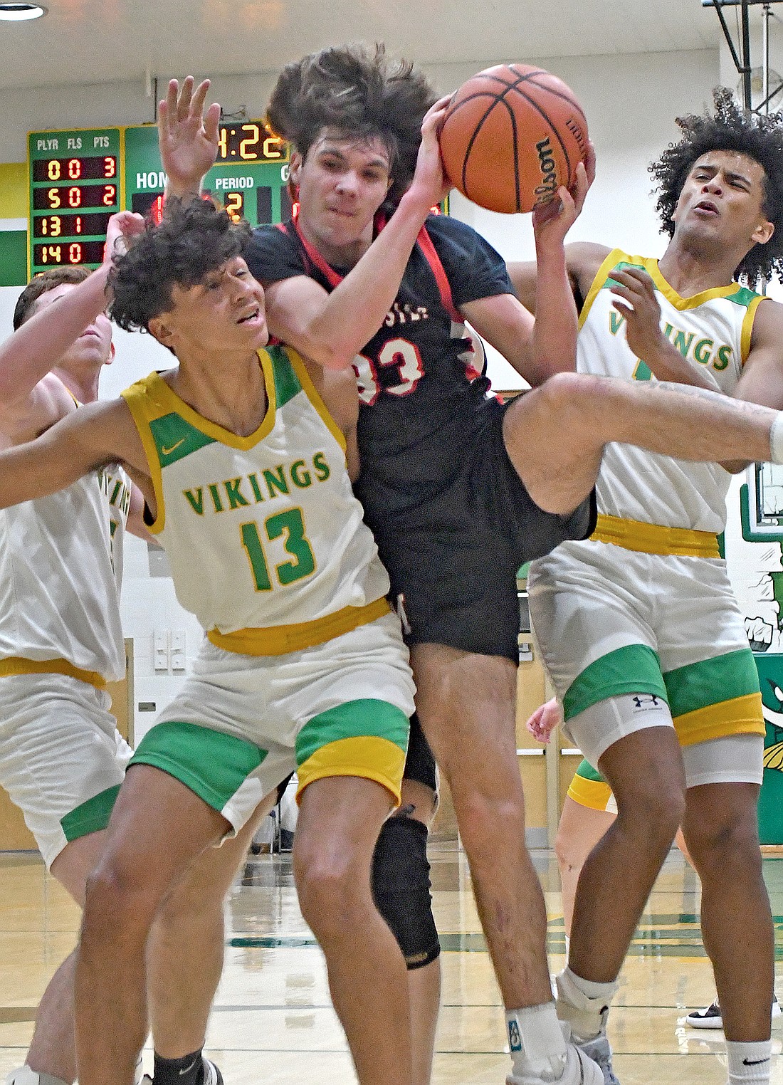 Senior Tallon Torpy of Manchester finds himself sandwiched between Valley players DeOndre Hamilton (L) and Owen Omondi...Nieter